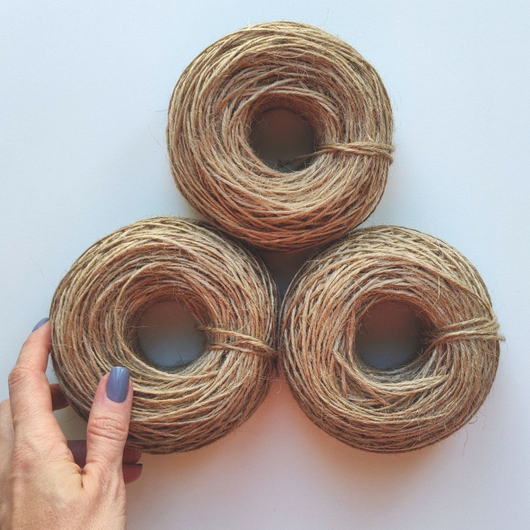 hand with mini balls of 1.5mm jute cord
